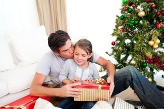 A dad opening presents with daughter